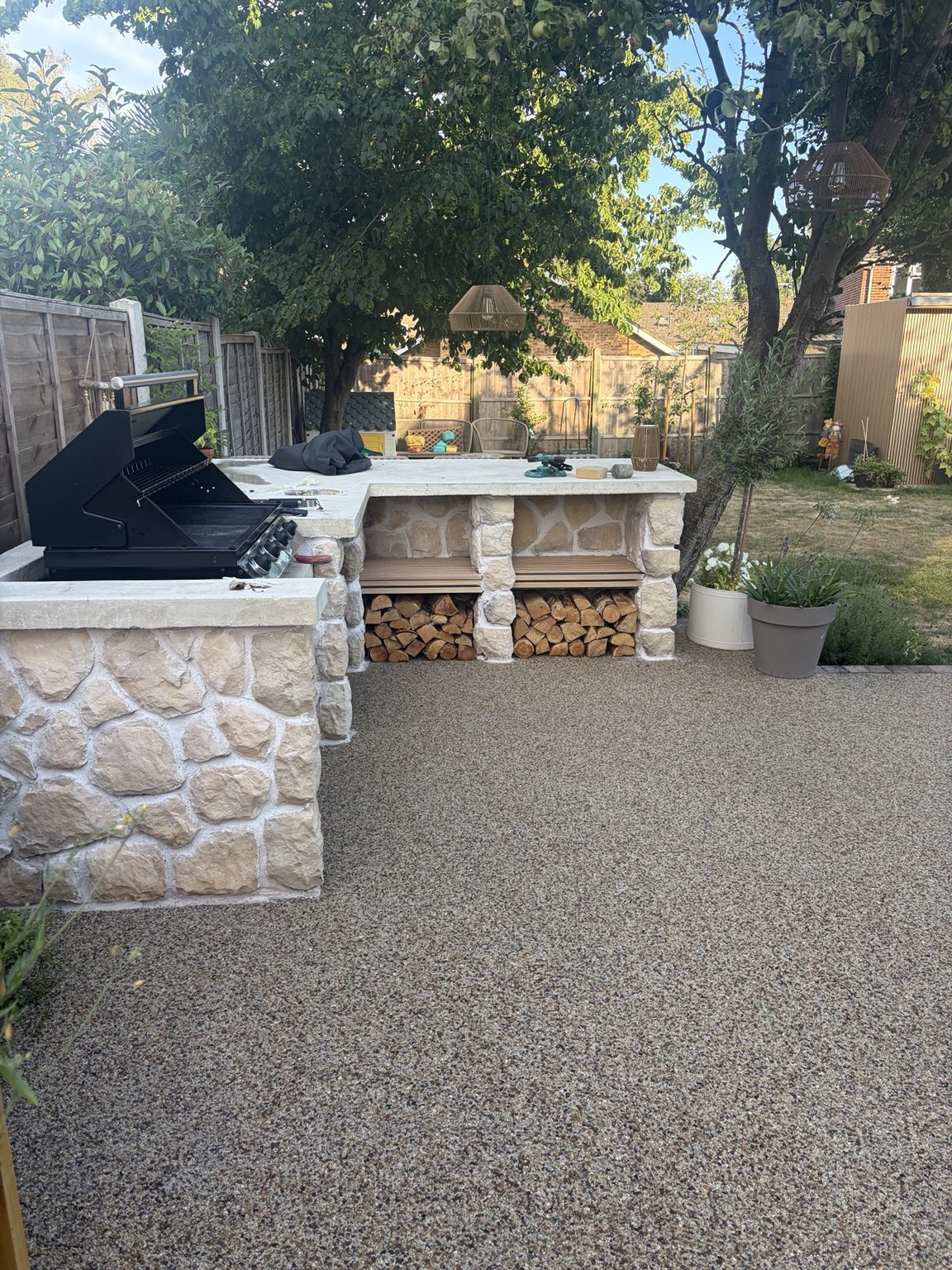 Outdoor kitchen with natural stonework and barbecue